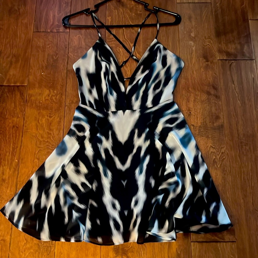 Bebe skater style dress. Small. Cross back straps. Back sip. Animal print.